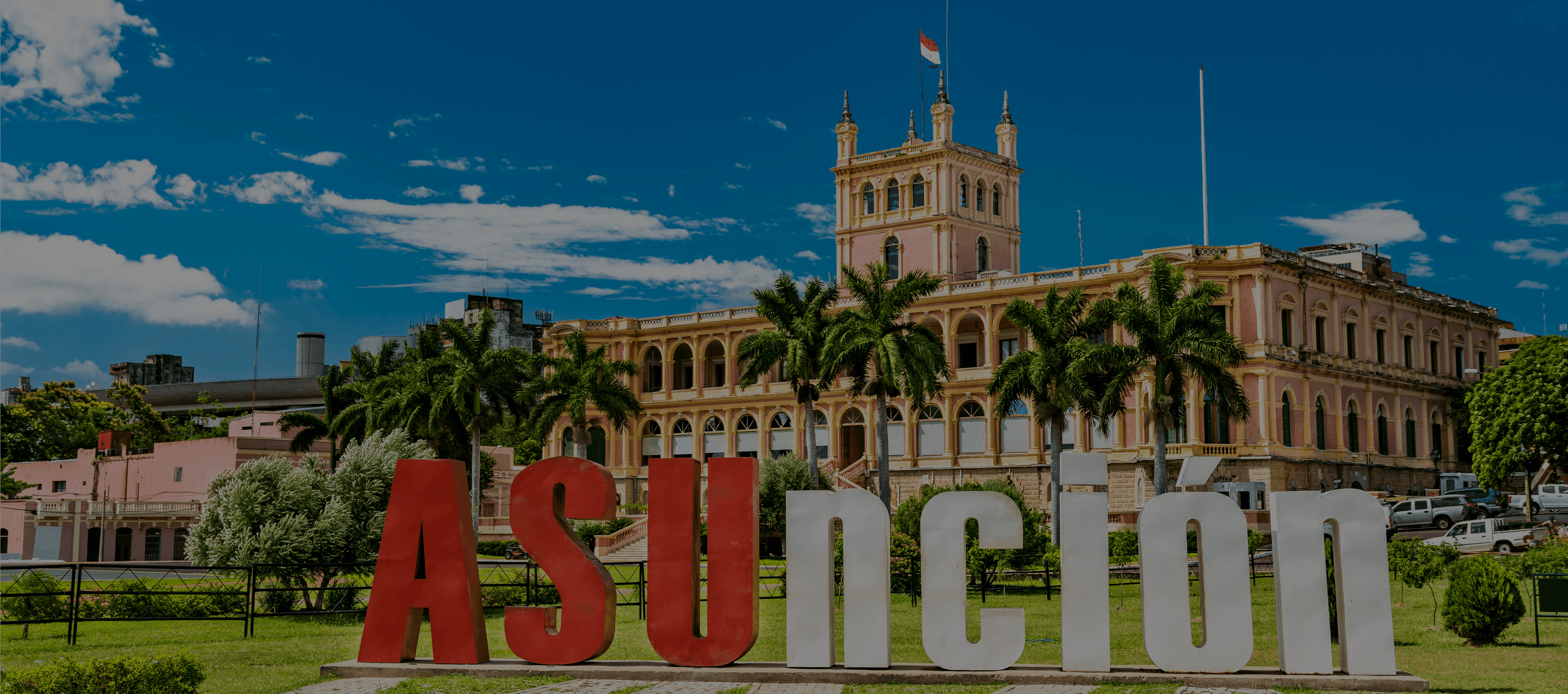 Palace of López in Asunción, Paraguay, with a large 'ASUNCIÓN' sign in the foreground.