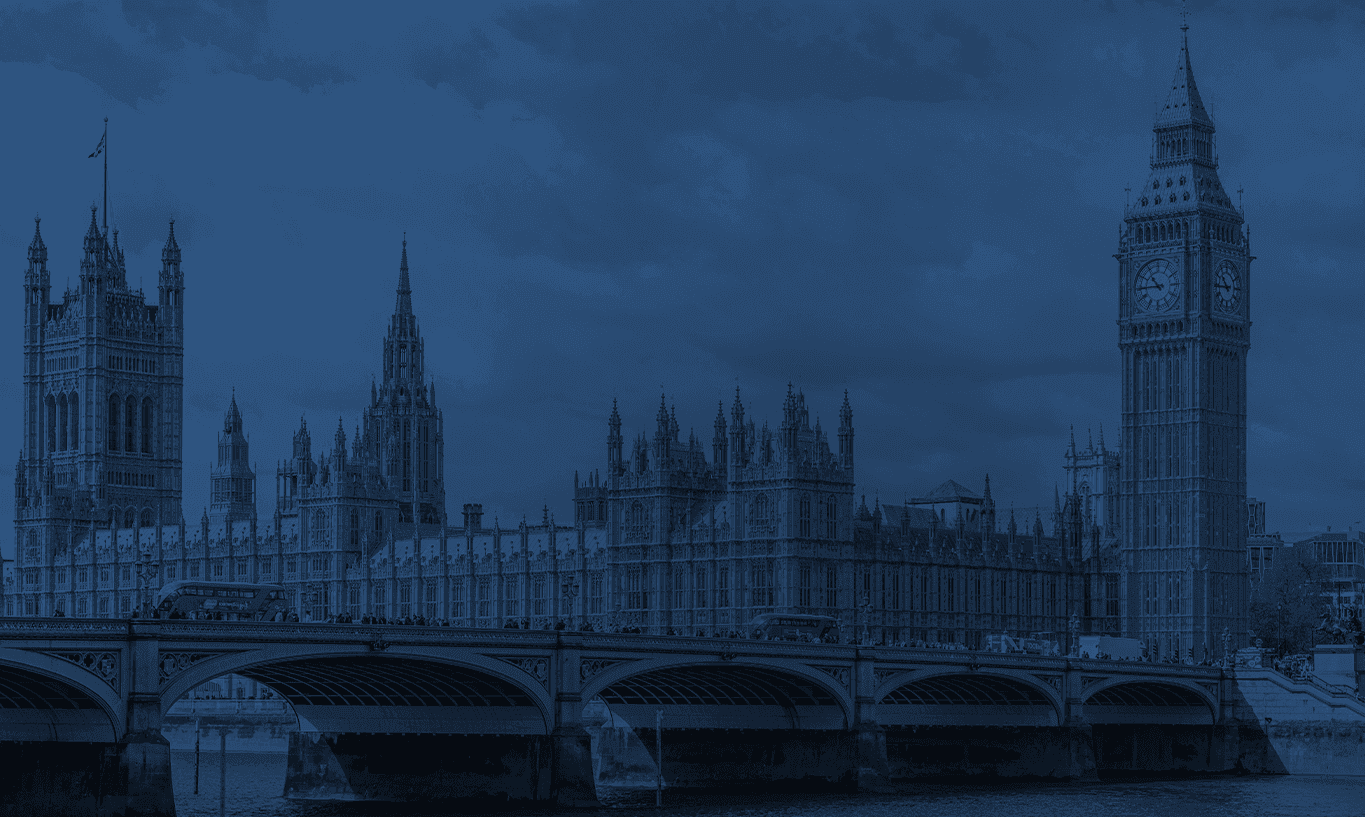 Blue-toned view of London's Palace of Westminster, Big Ben, and Westminster Bridge.